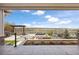 Expansive patio with built-in grill, pergola, and tranquil water views, perfect for outdoor entertaining and relaxation at 27381 E Lakeview Dr, Aurora, CO 80016