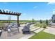 Landscaped patio area complete with lounge seating, pergola, hot tub and an outdoor grill at 27381 E Lakeview Dr, Aurora, CO 80016