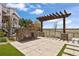 Outdoor patio featuring a cozy stone fireplace and pergola, perfect for relaxing evenings and outdoor gatherings at 27381 E Lakeview Dr, Aurora, CO 80016