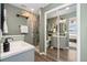 Serene bathroom with a glass shower, modern vanity, and a mirror that reflects the bedroom at 7076 W 83Rd Way, Arvada, CO 80003