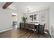 Dining room with a modern chandelier and a large window, with wood flooring at 7076 W 83Rd Way, Arvada, CO 80003