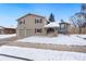 Charming two-story home with an attached two-car garage and snow covered yard at 7076 W 83Rd Way, Arvada, CO 80003