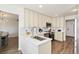 Bright and airy kitchen with white cabinets, stainless steel appliances, and a large sink at 7076 W 83Rd Way, Arvada, CO 80003