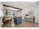 Inviting living room with wood floors, beams, stylish furnishings, and ample natural light at 7076 W 83Rd Way, Arvada, CO 80003