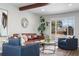 Comfortable living room featuring a brown leather sofa, beams, and a window with a view at 7076 W 83Rd Way, Arvada, CO 80003