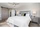 Inviting main bedroom with ceiling fan, rustic barn door, and windows providing natural light at 7076 W 83Rd Way, Arvada, CO 80003