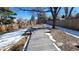 Fenced backyard with a gray deck providing space for outdoor relaxation at 8094 Kline Ct, Arvada, CO 80005