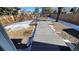 Large backyard with a new wooden deck and partial snow cover at 8094 Kline Ct, Arvada, CO 80005