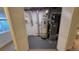 Basement utility room with water heater and furnace behind louvered doors at 8094 Kline Ct, Arvada, CO 80005