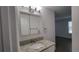 Updated bathroom vanity showcasing modern lighting and granite countertop at 8094 Kline Ct, Arvada, CO 80005