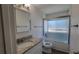 Bright bathroom featuring a shower and tub with a modern glass door and granite countertops at 8094 Kline Ct, Arvada, CO 80005