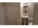 Powder room featuring a pedestal sink and modern fixtures at 8094 Kline Ct, Arvada, CO 80005