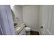 Contemporary half-bathroom with granite countertop, modern sink, and wood-look flooring at 8094 Kline Ct, Arvada, CO 80005