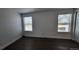 Bedroom featuring hardwood floors and two windows providing natural light at 8094 Kline Ct, Arvada, CO 80005