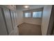 Neutral bedroom with carpet floors and two windows providing natural light at 8094 Kline Ct, Arvada, CO 80005