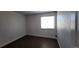 Simple bedroom with hardwood floors and a window providing natural light at 8094 Kline Ct, Arvada, CO 80005