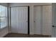 Bedroom featuring hardwood floors and two large sliding door closets at 8094 Kline Ct, Arvada, CO 80005