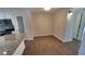 Bright dining room with new vinyl flooring, access to kitchen, and white trim at 8094 Kline Ct, Arvada, CO 80005