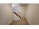 Hallway with carpeted stairs and white railing leading to upper level at 8094 Kline Ct, Arvada, CO 80005