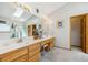 Bright bathroom features double sinks, a large mirror, and a skylight at 5134 S Ouray Ct, Centennial, CO 80015