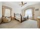 Primary bedroom with a four-poster bed, corner chair and two windows at 5134 S Ouray Ct, Centennial, CO 80015