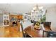 Dining room area featuring hardwood floors and a chandelier that connects to an open kitchen at 5134 S Ouray Ct, Centennial, CO 80015