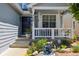 Inviting front porch with decorative accents, a charming fountain, and well maintained plants at 5134 S Ouray Ct, Centennial, CO 80015