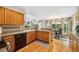 Kitchen with hardwood floors, wooden cabinets and stainless steel sink featuring windows for lots of light at 5134 S Ouray Ct, Centennial, CO 80015