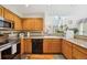 Well-lit kitchen with wooden cabinets, granite countertops, and modern appliances at 5134 S Ouray Ct, Centennial, CO 80015