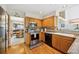 Spacious kitchen featuring stainless steel appliances, wooden cabinets and hardwood floors at 5134 S Ouray Ct, Centennial, CO 80015