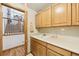 Laundry room with wooden cabinets, utility sink, and open doorway to staircase at 5134 S Ouray Ct, Centennial, CO 80015
