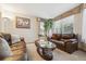 Cozy living room featuring comfortable leather sofas and natural lighting at 5134 S Ouray Ct, Centennial, CO 80015