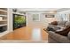 Bright living room with hardwood floors, a cozy sofa, large TV, and natural light from the window at 5134 S Ouray Ct, Centennial, CO 80015