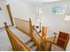 View from the top of the open staircase featuring wood railing and carpeted steps at 5134 S Ouray Ct, Centennial, CO 80015