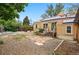 Spacious backyard with garden beds, a small deck and stairs, and a low fence in the background at 9390 W 14Th Ave, Lakewood, CO 80215