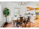 Bright dining room with hardwood floors, modern chandelier, and view to the kitchen at 9390 W 14Th Ave, Lakewood, CO 80215