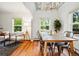 Dining room with hardwood floors and a view to the living room with a modern white sofa at 9390 W 14Th Ave, Lakewood, CO 80215