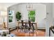 Bright dining room with hardwood floors, modern lighting, and a view of the outdoors through large windows at 9390 W 14Th Ave, Lakewood, CO 80215