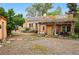 Charming home featuring a pergola-covered patio, solar panels, and a spacious mulch yard at 9390 W 14Th Ave, Lakewood, CO 80215