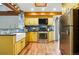 Spacious kitchen features custom cabinets, stainless steel appliances, and hardwood floors at 9390 W 14Th Ave, Lakewood, CO 80215