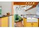 Kitchen with custom cabinets and a farmhouse sink overlooking the dining area and the living area at 9390 W 14Th Ave, Lakewood, CO 80215