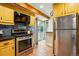 Updated kitchen features stainless steel appliances, wood beam, and access to the backyard at 9390 W 14Th Ave, Lakewood, CO 80215
