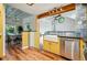 Kitchen with custom cabinets and a farmhouse sink overlooking the dining area and the living area at 9390 W 14Th Ave, Lakewood, CO 80215