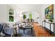Open-concept living and dining area with hardwood floors, large windows, and modern decor at 9390 W 14Th Ave, Lakewood, CO 80215