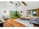 Bright living room with a wood burning stove and a white vaulted ceiling showcasing wooden beams at 9390 W 14Th Ave, Lakewood, CO 80215