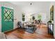 Bright living room featuring hardwood floors, stylish furnishings, and a view into the dining area at 9390 W 14Th Ave, Lakewood, CO 80215