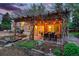 Outdoor patio area features a dining table beneath a stylish pergola adorned with string lights at 9390 W 14Th Ave, Lakewood, CO 80215