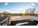 Rooftop deck with city views, brick wall, metal railing, and sunset view at 2393 King St, Denver, CO 80211