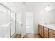Bathroom boasts double sinks, shower, and wood cabinets at 13402 E 110Th Way, Commerce City, CO 80022