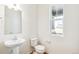 Simple and clean bathroom with pedestal sink and window at 13402 E 110Th Way, Commerce City, CO 80022